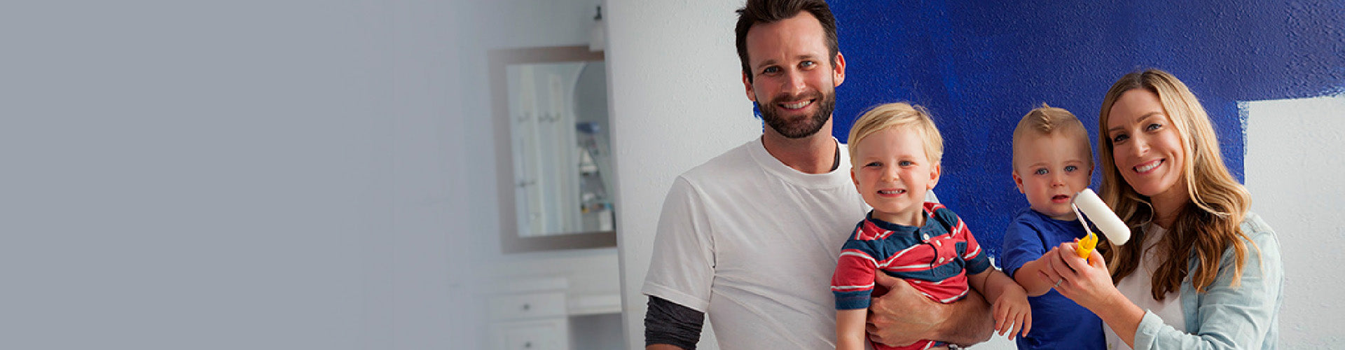 Foam Pro Family of four painting walls blue with foam pro rollers.
